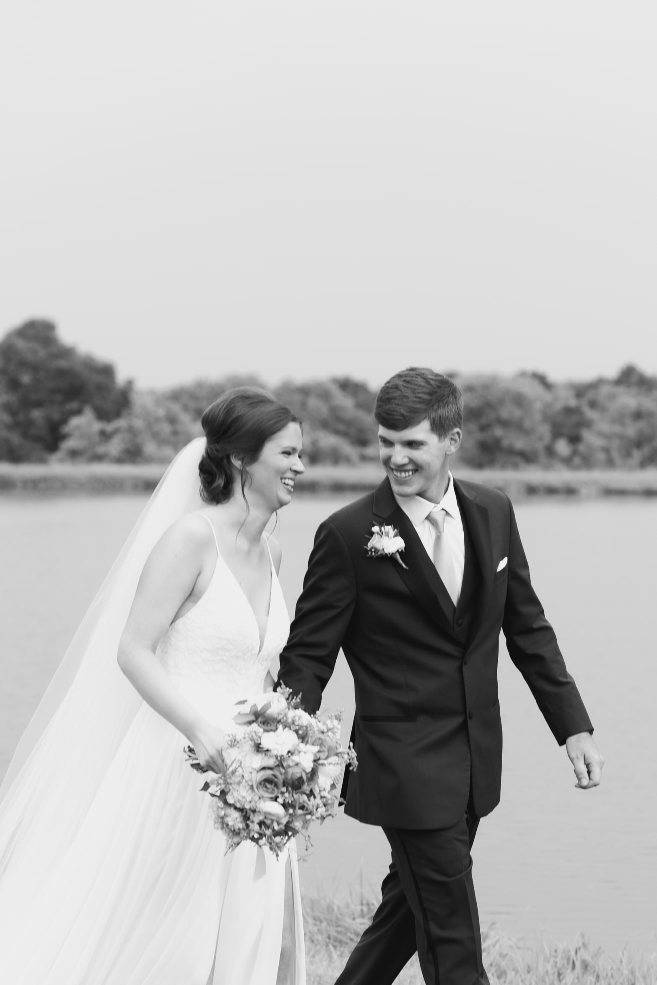 A Nashville Bride and Groom hold hands and smile right after their ceremony on their wedding day.